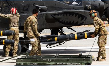 AGM-114 Hellfire missile loaded onto an AH-64E Apache helicopter