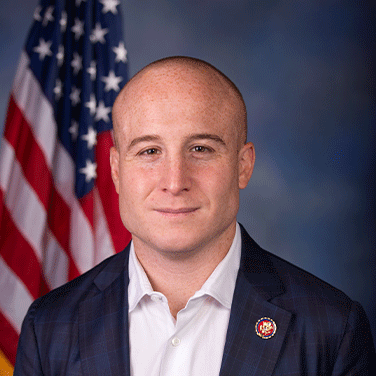 Picture of Max Rose in front of American flag