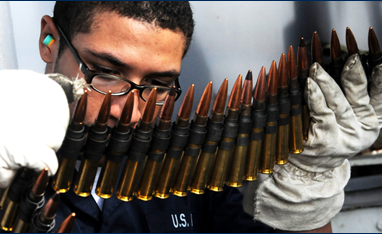 Photo of African American man looking at ammunition 